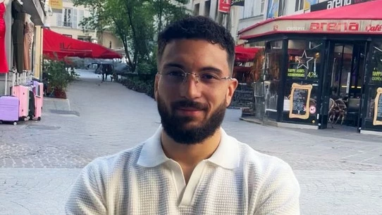 jeune souriant à la terrasse d'un café